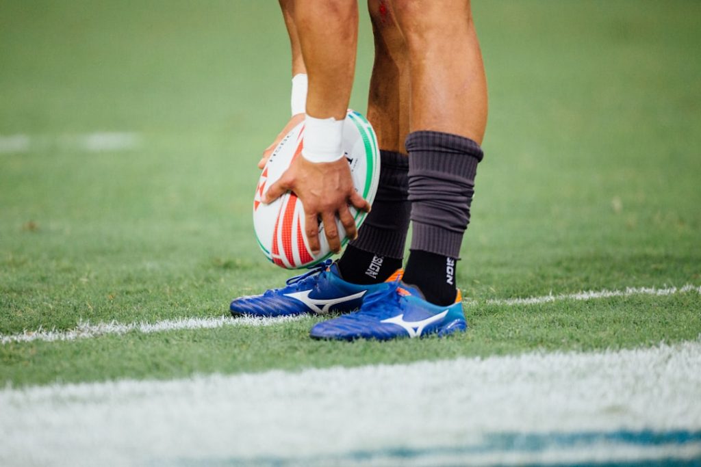 man-holding-rugby-ball-jub7dpwc2u8